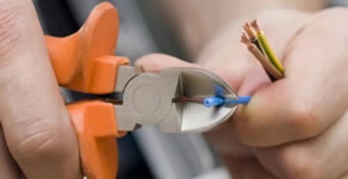 licensed electrician performing precise wire cutting and preparation during electrical service in Lancaster, PA